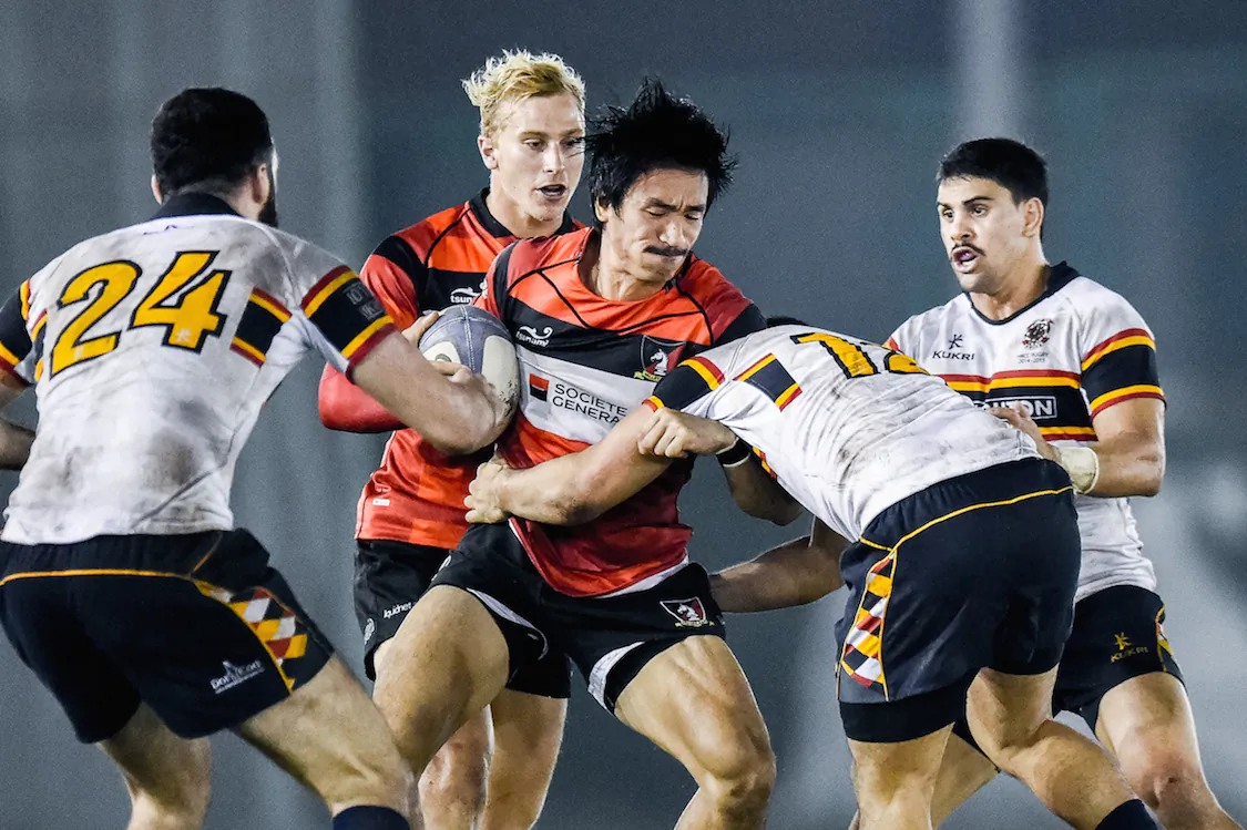 Valley wing Salom Yiu Kam Shing tries to fend HKCC centre Danny Atamu's tackle during their Premiership match at Aberdeen Sports Ground on Saturday, Nov. 29, 2014. (HKRFU)
