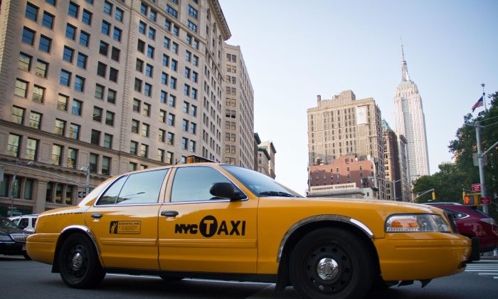 A taxi drives across 23rd Street in the Flat Iron District of Manhattan on July 7, 2012. (Benjamin Chasteen/Epoch Times