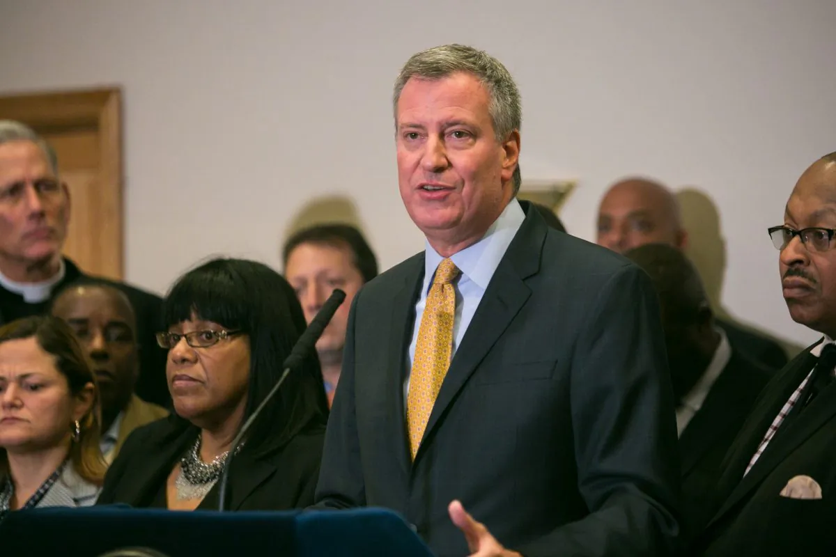 New York City Mayor Bill de Blasio speaks in Staten Island on Dec. 3, 2014 about a Staten Island grand jury decision not to bring criminal charges to police officer Daniel Pantaleo who placed Eric Garner in a chokehold resulting in death. Mayor Blasio is flanked by other officials, clergy, and friends and family of Eric Garner. (Benjamin Chasteen/Epoch Times)