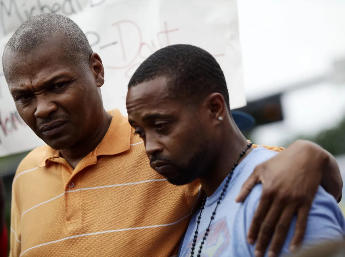 Louis Head (R), stepfather of 18 year-old Michael Brown, and Brown's cousin Eric Davis (L) attend a news conference on Aug. 15, 2014 in Ferguson, Mo. Michael Brown was killed in broad daylight on Aug. 9, 2014, with witnesses and law enforcement providing conflicting accounts of how the 18-year-old lost his life. (Joshua Lott/AFP/Getty Images)