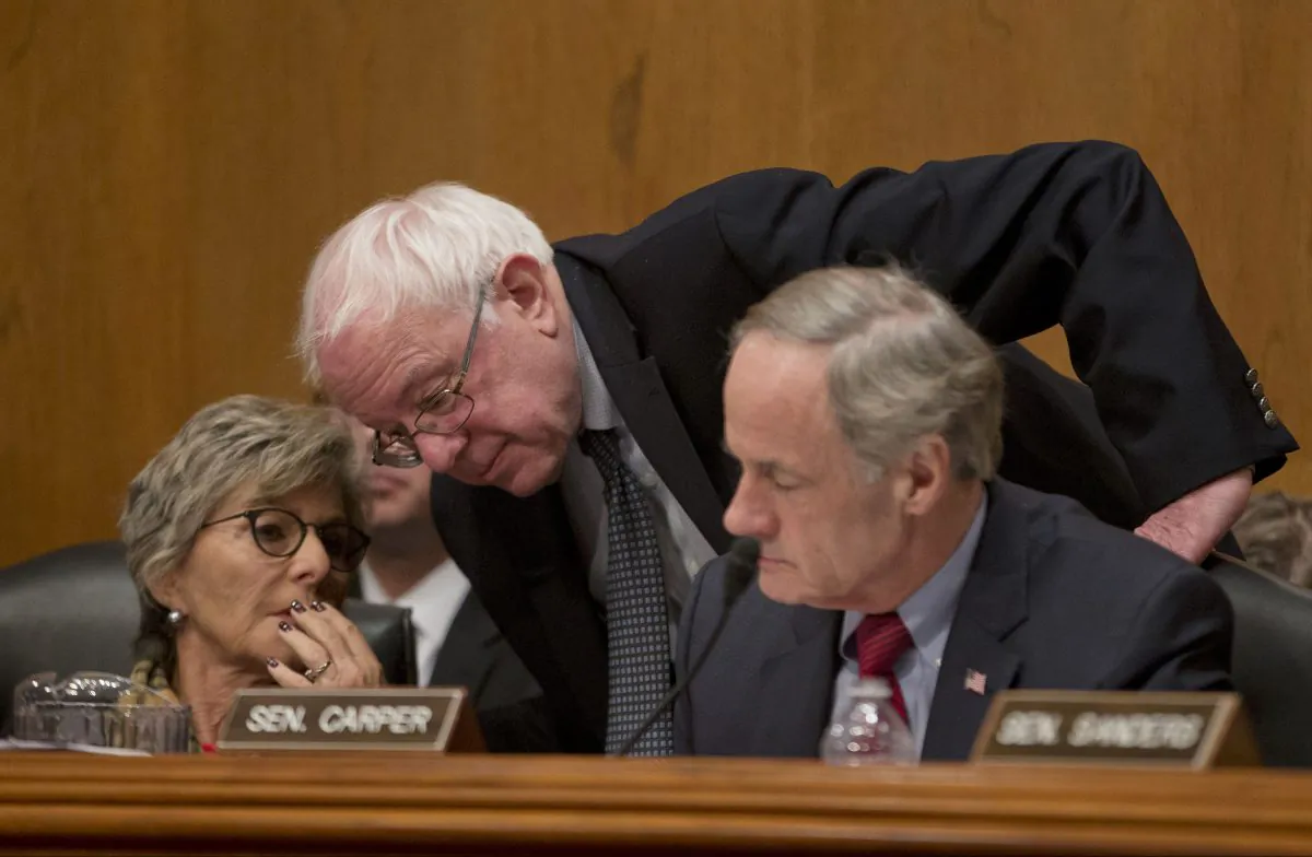 Senate Environment and Public Works Committee Chair Sen. Barbara Boxer (D-Calif.) left, confers with Sen. Bernie Sanders (I-Vt.) center, and Senate subcommittee on Clean Air and Nuclear Safety Chairman Sen. Tom Carper (D-Del.) on Capitol Hill in Washington on Jan. 30, 2014. (AP Photo)