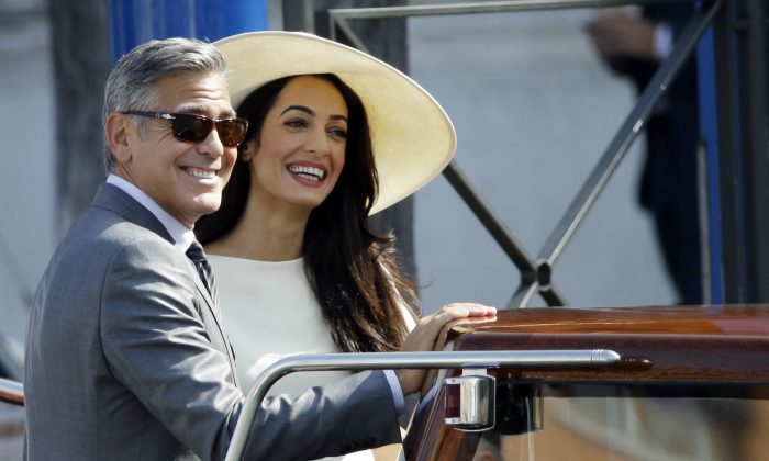 George Clooney and Amal Alamuddin leave Venice's city hall, Italy, Monday, Sept. 29, 2014. (AP Photo/Andrew Medichini)