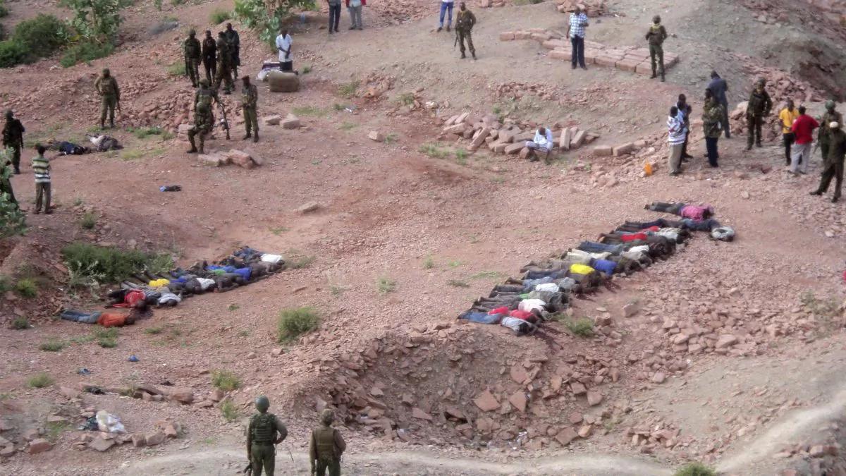 Soldiers of Kenyan Defence Forces look over the bodies of some 36 Kenyans  as they lie at a quarry, Tuesday, Dec. 2, 2014. Kenya police say that at least 36 quarry workers were killed in an attack in northern Kenya  by suspected Islamic extremists from Somalia. Kenyan police chief David Kimaiyo confirmed the workers were killed early Tuesday in Mandera County. (AP Photo)