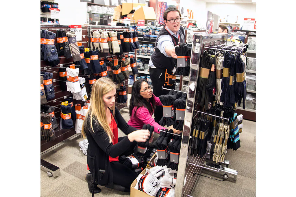 Towne East J.C. Penney employees (L-R) Tori Goldsmith, Carla Fuller and Brian Hill stock men's socks as they prepare for Thanksgiving Day sales, in Wichita, Kan., on Nov. 18, 2014. The Institute for Supply Management, a trade group of purchasing managers, issues its index of non-manufacturing activity for November on Wednesday, Dec. 3, 2014. (AP Photo/The Wichita Eagle, Mike Hutmacher)