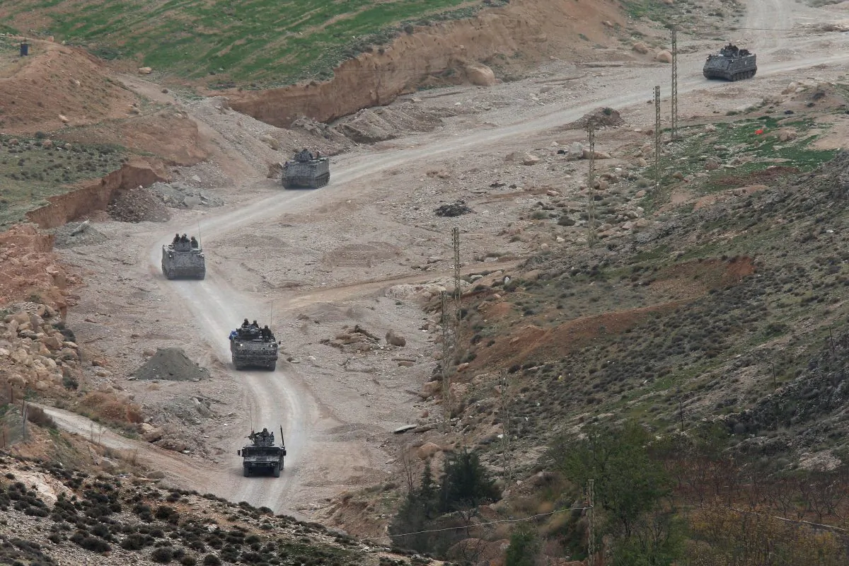 Lebanese army special forces in armored personnel carriers patrol near the area militants ambushed Lebanese soldiers, in Ras Baalbek town, eastern Lebanon, on Wednesday, Dec. 3, 2014. On Tuesday, militants ambushed a Lebanese army patrol near the frontier, killing several soldiers and wounding one, Lebanon's military said. Lebanese troops have clashed repeatedly with militants along the border with Syria since August. (AP Photo/Hussein Malla)