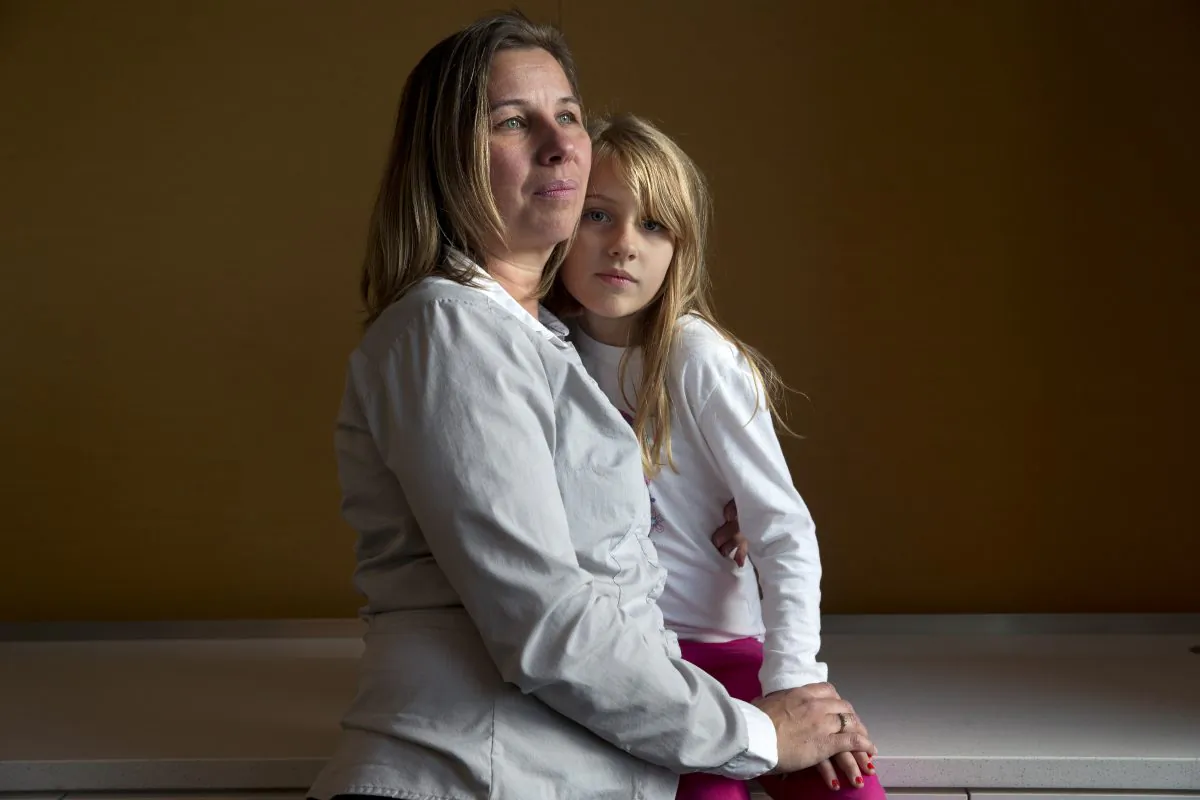 Peggy Young, of Lorton, Va., with her daughter Triniti, 7, in Washington, on Nov. 14, 2014. (AP Photo/Jacquelyn Martin)