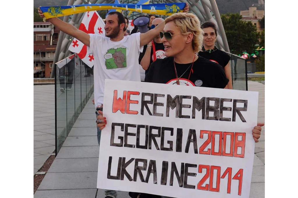 Protesters hold posters and shout slogans during a rally in support of Ukraine and against the Russian President Vladimir Putin, in Tbilisi, on Aug. 26, 2014. (Vano Shlamov/AFP/Getty Images)