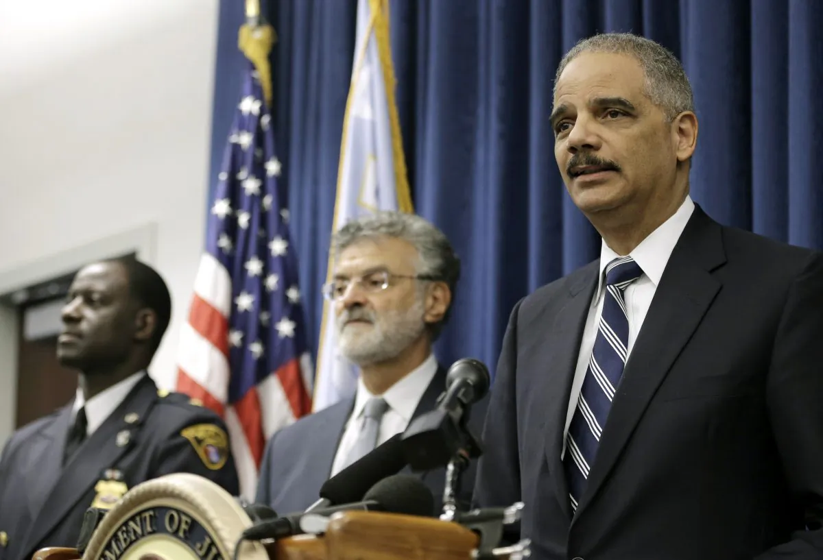 U.S. Attorney General Eric Holder (R), Cleveland Mayor Frank Jackson (C), and Cleveland police chief Calvin Williams (L) in Cleveland on Dec. 4, 2014. (AP Photo/Tony Dejak)
