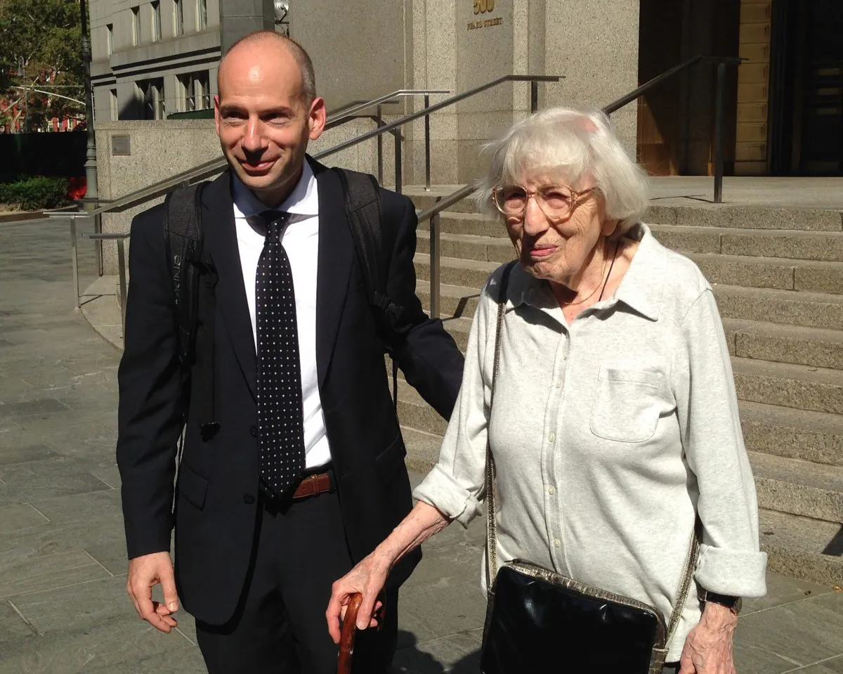 Miriam Moskowitz leaves federal court with her lawyer Guy Eddon in Manhattan, N.Y., on Aug. 25, 2014. Moskowitz lost her bid to persuade a judge to erase her 1950 conviction for conspiracy to obstruct justice in the run-up to the atomic spying trial of Julius and Ethel Rosenberg. (AP Photo/Lawrence Neumeister)