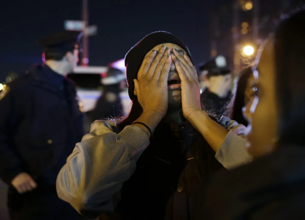 A woman is overcome with emotion during a protest against the grand jury’s decision in the Eric Garner case in Times Square on Wednesday. (AP Photo/Seth Wenig)