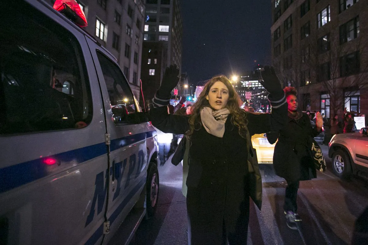 A protester puts her hands up in solidarity with Eric Garner, the black unarmed man who died after being put in a chokehold by a white police officer, during protests on Dec. 4, 2014 in Manhattan, New York. (Samira Bouaou/Epoch Times)