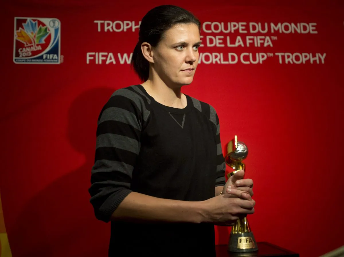 Canadian women’s national soccer team captain Christine Sinclair stands near the Women’s World Cup trophy following a news conference Friday, Dec. 5, 2014 in Ottawa. (The Canadian Press/Adrian Wyld)