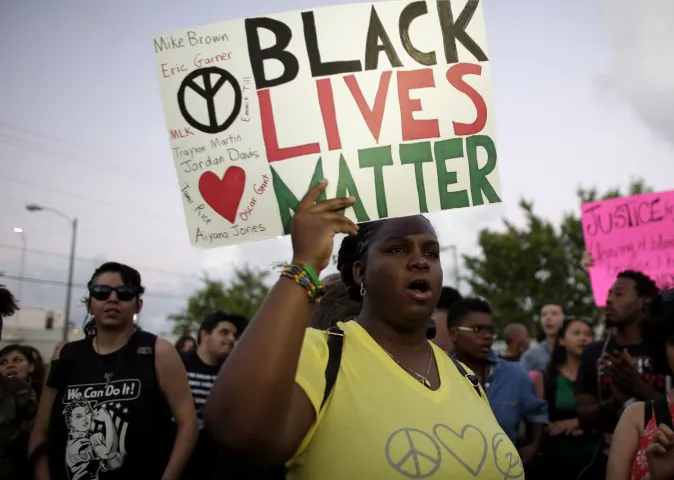 A woman holds a "Black Lives Matter" sign (AP Photo/Lynne Sladky)