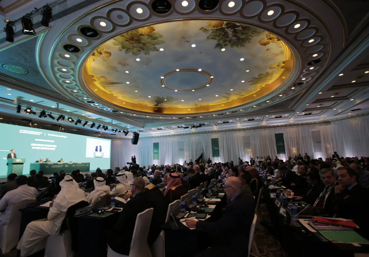 Delegates listen to United Kingdom's Foreign Secretary Philip Hammond, left on the podium, as he speaks during the 10th International Institute for the Strategic Studies in Manama, Bahrain, Saturday, Dec. 6, 2014. Britain's top diplomat says his nation has signed a deal with the Gulf Arab nation of Bahrain to bolster the United Kingdom's military presence in the region. Foreign Secretary Philip Hammond announced the deal Saturday at a security conference in the Bahraini capital, Manama, where he assured Gulf allies that "your security concerns are our security concerns." (AP Photo/Hasan Jamali)