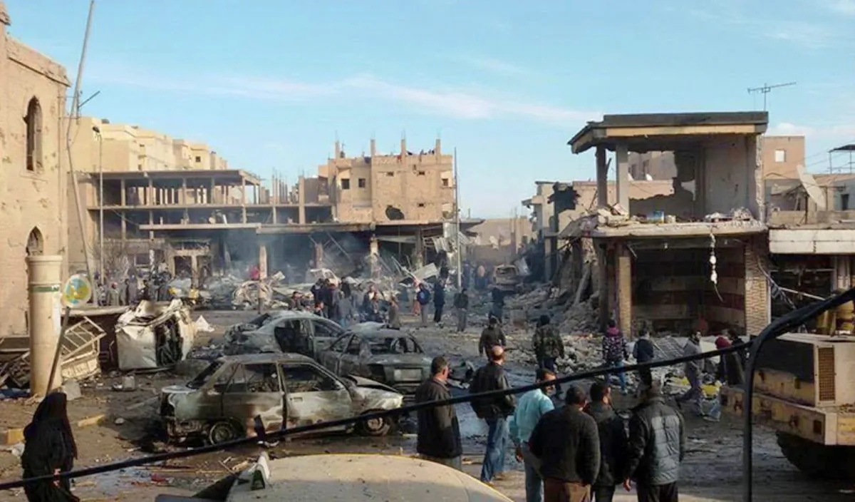 A burned cars and damaged buildings on a street after Syrian government forces airstrikes struck a popular market near a museum and an industrial neighborhood in Raqqa city, north Syria, on Nov. 25, 2014. The death toll from a series of Syrian government airstrikes on the Islamic State group's stronghold in northeastern Syria has risen to at least 150, making it one of the deadliest attacks on the city of Raqqa in the past three years. (AP Photo/Raqqa Is Being Slaughtered Silently)