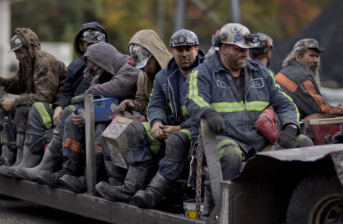 Coal miners return on a buggy after working a shift underground at the Perkins Branch Coal Mine in Cumberland, Ky., on Oct. 15, 2014. As recently as the late 1970s, there were more than 350 mines operating at any given time in Harlan County. Today, it's around 40. (AP Photo/David Goldman)