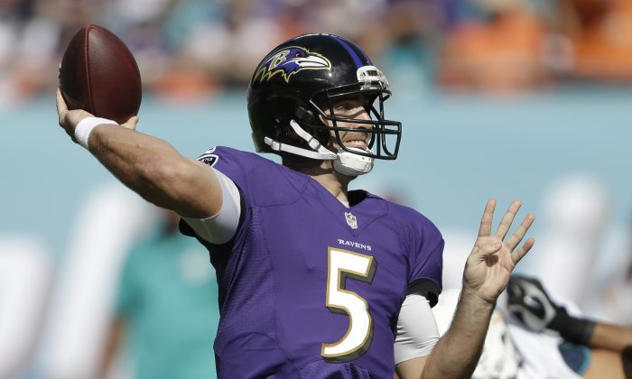 Baltimore Ravens quarterback Joe Flacco (5) looks to pass during the first half of an NFL football game against the Miami Dolphins, Sunday, Dec. 7, 2014, in Miami Gardens, Fla. (AP Photo/Wilfredo Lee)