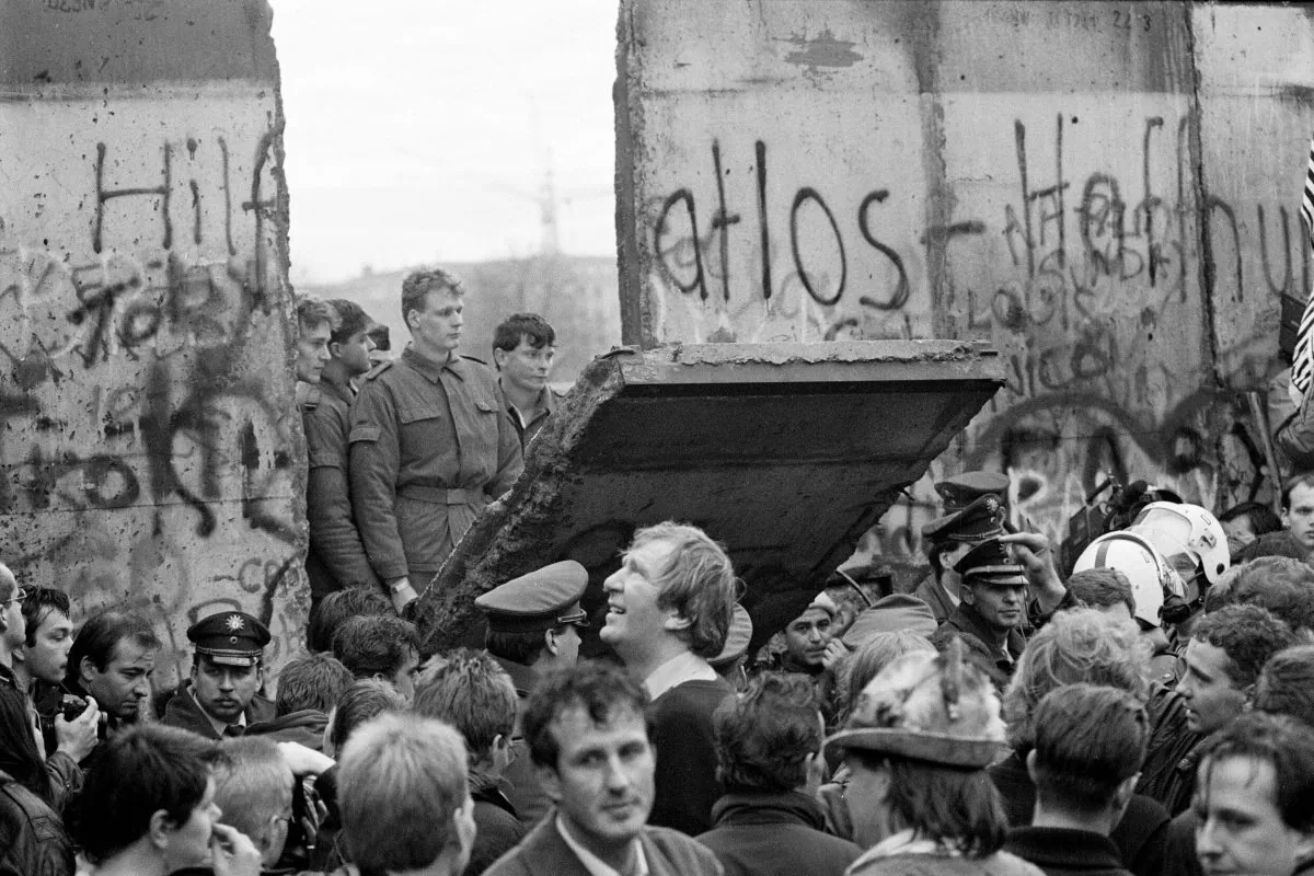 West Berliners crowd in front of the Berlin Wall early Nov. 11, 1989, as they watch East German border guards demolishing a section of the wall in order to open a new crossing point between East and West Berlin, near the Potsdamer Square. (Gerard Malie/AFP/Getty Images)