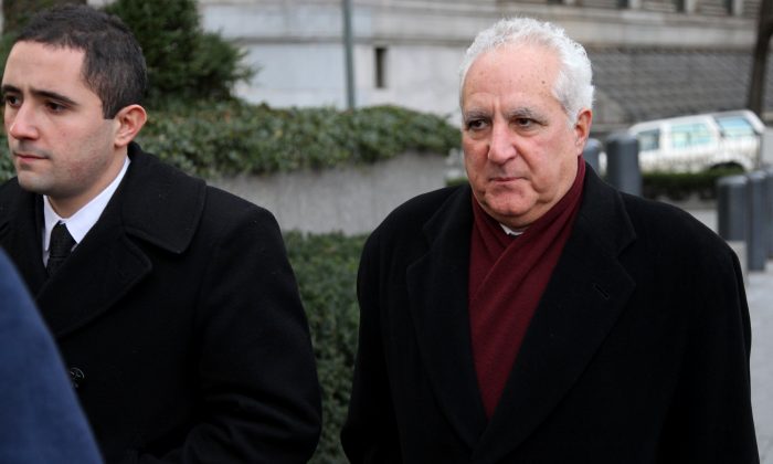  In a Dec. 15, 2010 file photo, Daniel Bonventre, right, a former employee of Bernard Madoff, arrives before appearing in federal court in New York. Bonventre, the first of five ex-employees of imprisoned Ponzi king Bernard Madoff is scheduled to be sentenced Monday, Dec. 8, 2014 after a New York jury convicted them earlier this year.  (AP Photo/Craig Ruttle, File)