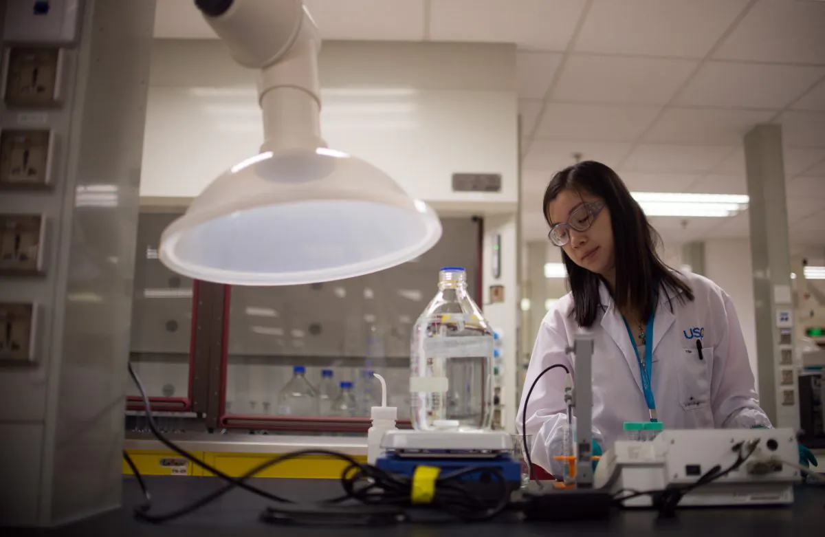 An employee weighs chemicals at a pharmaceutical company in China on Sept. 24, 2014. (Johannes Eisele/AFP/Getty Images)
