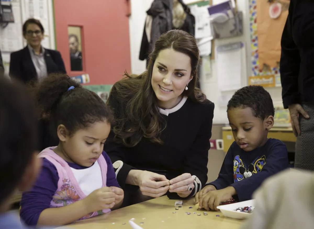 Kate, the Duchess of Cambridge, sits next to four-year-olds April, left, and Sammy in a pre-school class at the Northside Center for Childhood Development, Monday, Dec. 8, 2014 in New York. Kate and Prince William arrived in New York City on Sunday, their first official visit to the U.S. since a 2011 trip to California and their first taste of the Big Apple.(AP Photo/Seth Wenig, Pool)