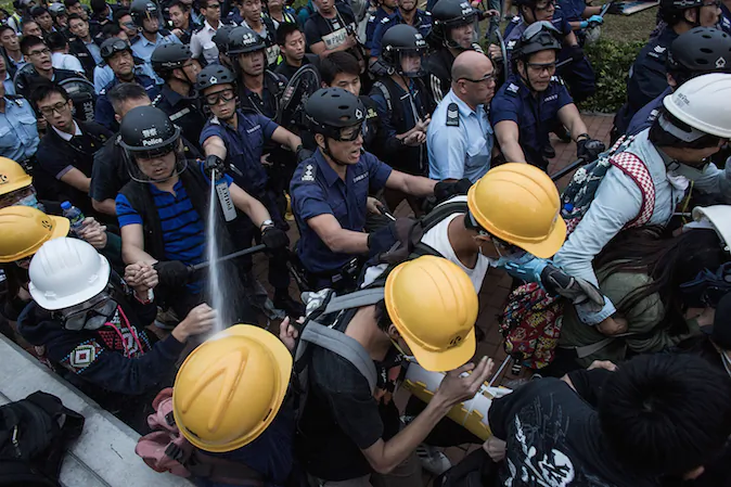 Riot police clash with pro-democracy protesters outside Central Government Complex at admiralty district on December 1, 2014 in Hong Kong. (Lam Yik Fei/Getty Images)