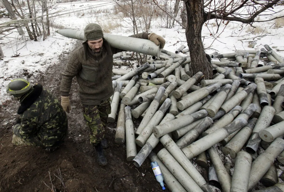 A Ukrainian artilleryman carries a shell past spent shell cases at their position near the eastern Ukrainian village Pisky, Donetsk region, to be fired at the position of pro-Russia separatists at Donetsk airport on Dec. 8, 2014. (Anatolii Stepanov/AFP/Getty Images)