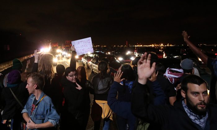 Protesters block interstate 80 during a demonstration over recent grand jury decisions in police-involved deaths on December 8, 2014 in Berkeley, California. (Justin Sullivan/Getty Images)
