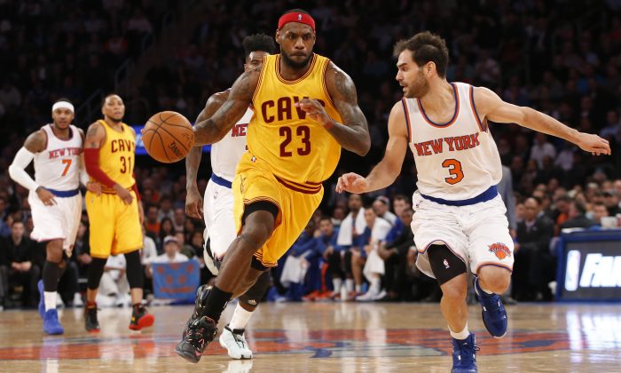 Cleveland Cavaliers forward LeBron James (23) drives toward the basket beside New York Knicks guard Jose Calderon (3) in the first half of an NBA basketball game at Madison Square Garden in New York, Thursday, Dec. 4, 2014. (AP Photo/Kathy Willens)
