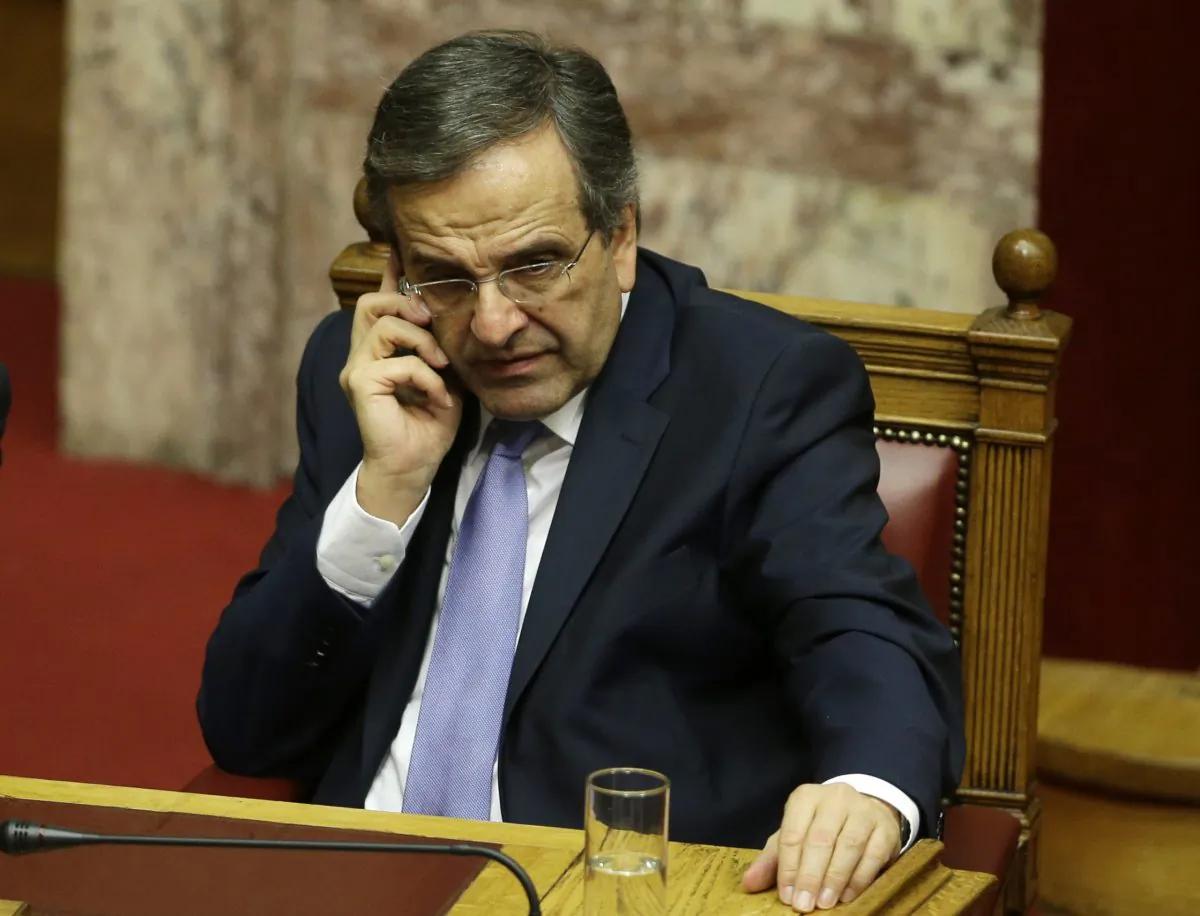 Greece's Prime Minister Antonis Samaras speaks on his cell phone after a parliament meeting for a vote on the country's 2015 budget in Athens on Dec. 8, 2014. In a televised address on Tuesday, Dec. 9, 2014, Samaras nominated Stavros Dimas, a senior figure in his conservative party and former EU commissioner for the environment, as the governments presidential candidate. Greek shares dived a day after the conservative-led government brought forward the date of a crucial presidential vote, raising a strong possibility of early general elections in the austerity-weary country. (AP Photo/Thanassis Stavrakis)