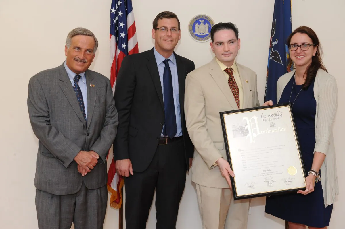 Dilip Chauhan accepting New York state proclamation from N.Y. State Assembly members David Weprin, Ed Brauestein, and Nily Rozic. (Jit Parekh)