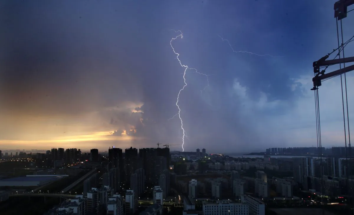 Lightning strikes at sunset in Wuhan, the capital of central China's Hubei Province, on Aug. 11, 2013. Real estate business has become an important part of Xi Jinping’s anti-corruption campaign against the Jiang faction. (STR/AFP/Getty Images)