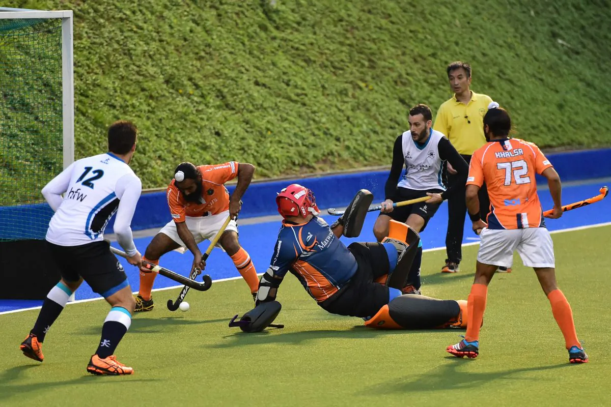 An important stop by the Khalsa-A defence during their HKHA Premier Division match against HKFC-A at King’s Park on Sunday Dec. 7, 2014. (Bill Cox/Epoch Times)