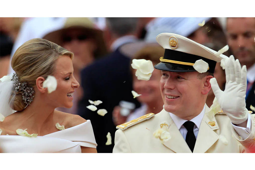 Prince Albert II of Monaco and Princess Charlene of Monaco depart from the Monaco palace after their religious wedding ceremony on July 2, 2011. Monaco's Princess Charlene has given birth to royal twins, Gabriella and Jacques, Wednesday, Dec. 10, 2014. (AP Photo/Jean Paul Pelissier)