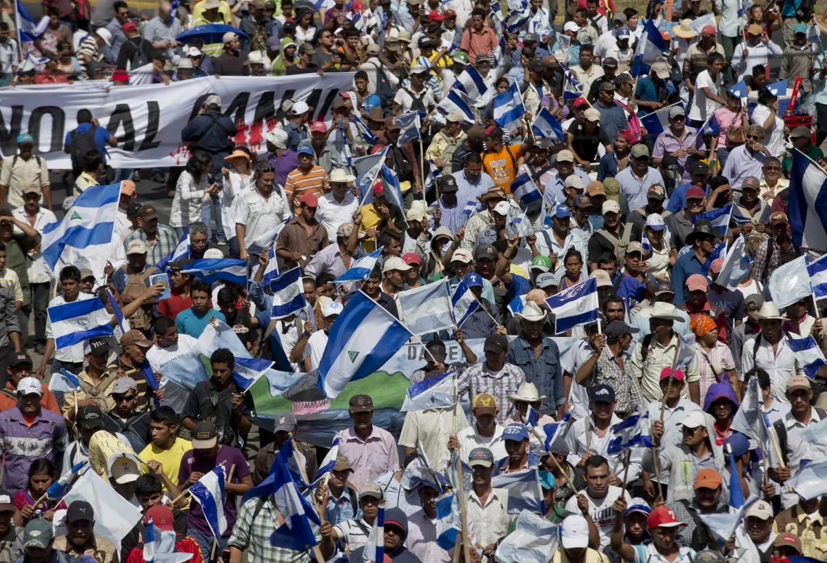 People takes part in a national march against the construction of the planned Nicaraguan interoceanic canal, in Managua, Nicaragua, Wednesday, Dec. 10, 2014. Building of the first phase of the multi-billion dollar, 173-mile canal starts on Dec. 22. (AP Photo/Esteban Felix)