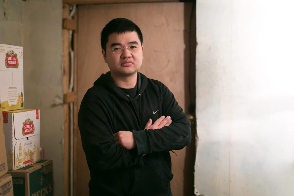 Jong-Min, 34, an undocumented immigrant who has been in the U.S. for most of his life, inside his family owned convenience store in Brooklyn, New York, on Dec. 8. 2014. Min is currently in the process of receiving a green card and wishes to go to law school. (Benjamin Chasteen/Epoch Times)
