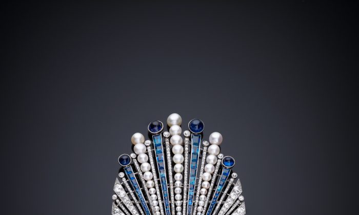 Aigrette designed by Paul Iribe, made by Robert Linzeler, Paris, 1910 in platinum set with emerald, sapphires, diamonds, and pearls. Paul Iribe set a carved Indian emerald into an aigrette, a form that would have ornamented the turban of a maharaja or a nizam. (Servette Overseas Limited 2013. All rights reserved.)