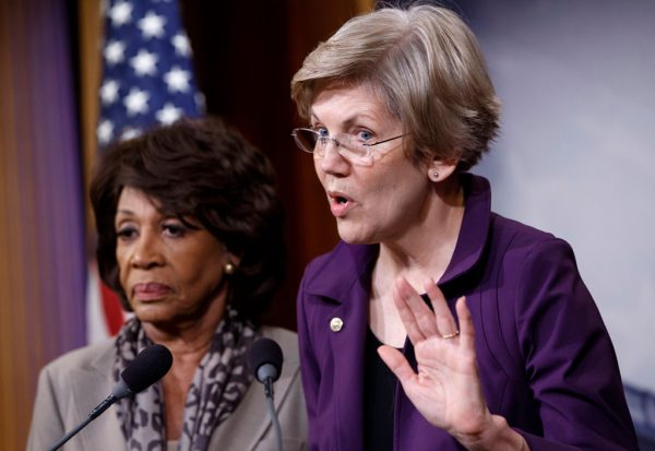 Sen. Elizabeth Warren (R) (D-Mass.), a member of the Senate Banking Committee, and Rep. Maxine Waters (D-Calif.), ranking member of the House Financial Services Committee, express their outrage to reporters that a huge, $1.1 trillion spending bill approved by the Republican-controlled House yesterday contains changes to the 2010 Dodd-Frank law that regulates complex financial instruments known as derivatives, Wednesday, Dec. 10, 2014, on Capitol Hill in Washington. Democratic support for the omnibus bill funding every corner of government faded Wednesday as liberal lawmakers erupted over a provision that weakens the regulation of risky financial instruments and another that allows more money to flood into political parties. (AP Photo/J. Scott Applewhite)