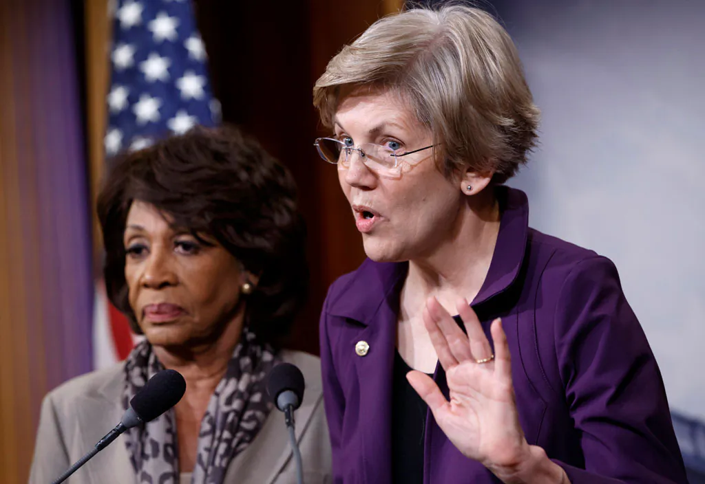 Sen. Elizabeth Warren (R) (D-Mass.), a member of the Senate Banking Committee, and Rep. Maxine Waters (D-Calif.), ranking member of the House Financial Services Committee, express their outrage to reporters that a huge, $1.1 trillion spending bill approved by the Republican-controlled House yesterday contains changes to the 2010 Dodd-Frank law that regulates complex financial instruments known as derivatives, Wednesday, Dec. 10, 2014, on Capitol Hill in Washington. Democratic support for the omnibus bill funding every corner of government faded Wednesday as liberal lawmakers erupted over a provision that weakens the regulation of risky financial instruments and another that allows more money to flood into political parties. (AP Photo/J. Scott Applewhite)