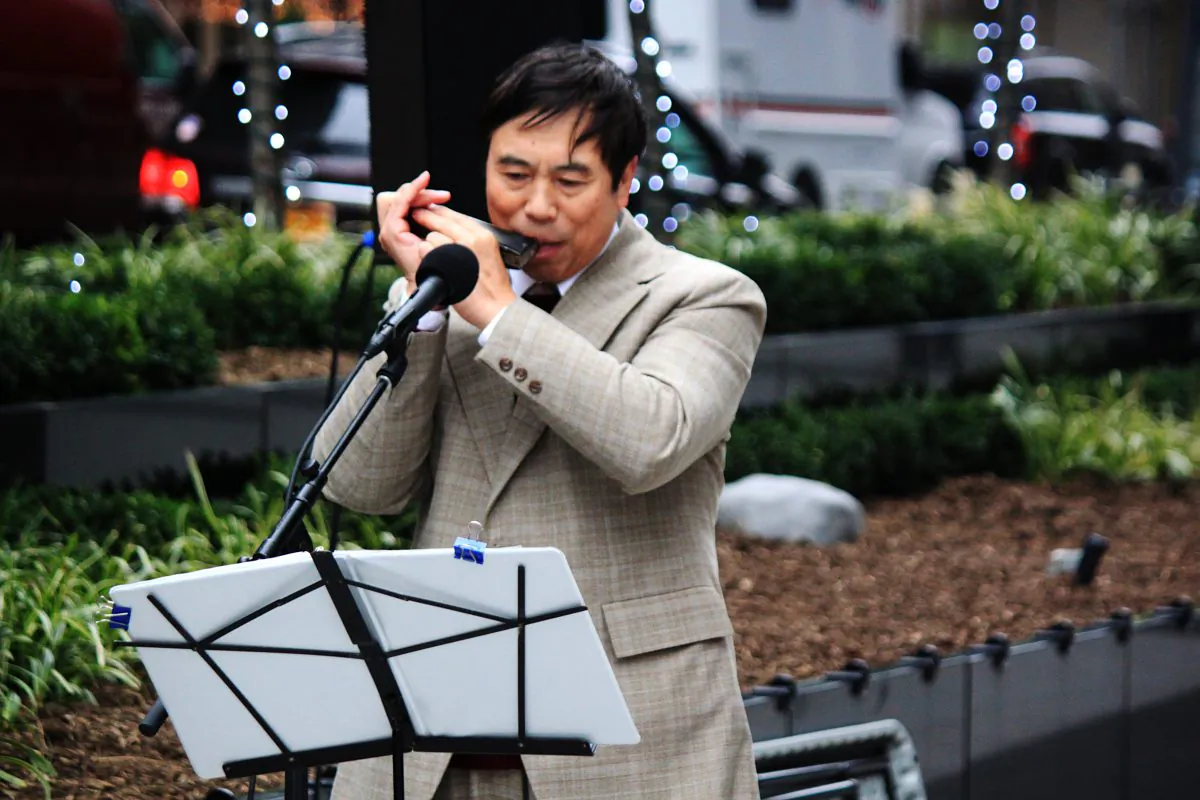 Harmonica virtuosos Jia-Yi He in a public performance for Sounds of the Season. (East Midtown Partnership)