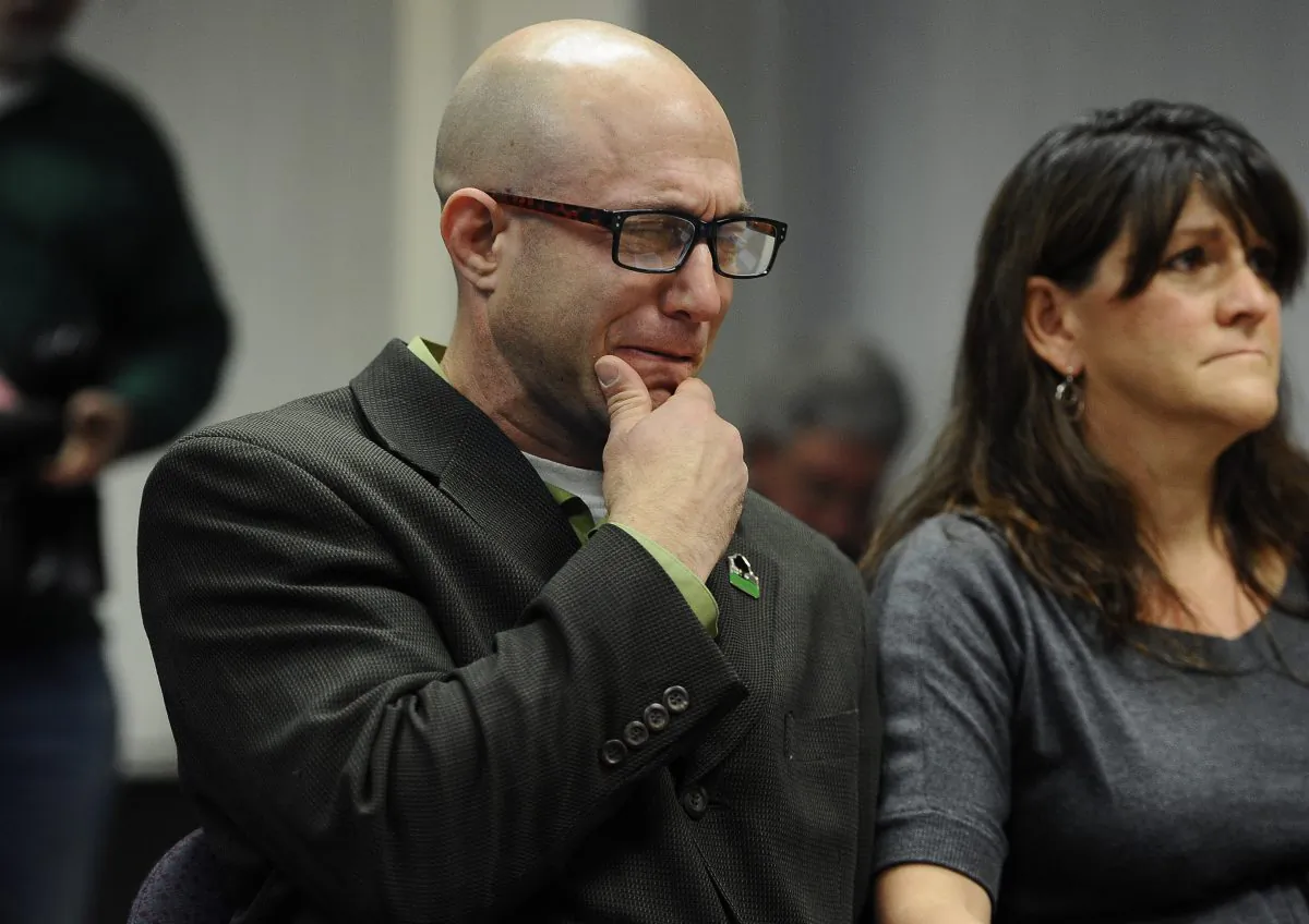 Jeremy Richman (L) weeps as he watches a video of his daughter, Sandy Hook Elementary school shooting victim Avielle Richman in Newtown, Conn., on Friday, Nov. 14, 2014. Days ahead of the Sandy Hook Elementary School shooting anniversary, advocates and lawmakers in New York on Dec. 11, 2014 called for stricter gun laws. (AP Photo/Jessica Hill)