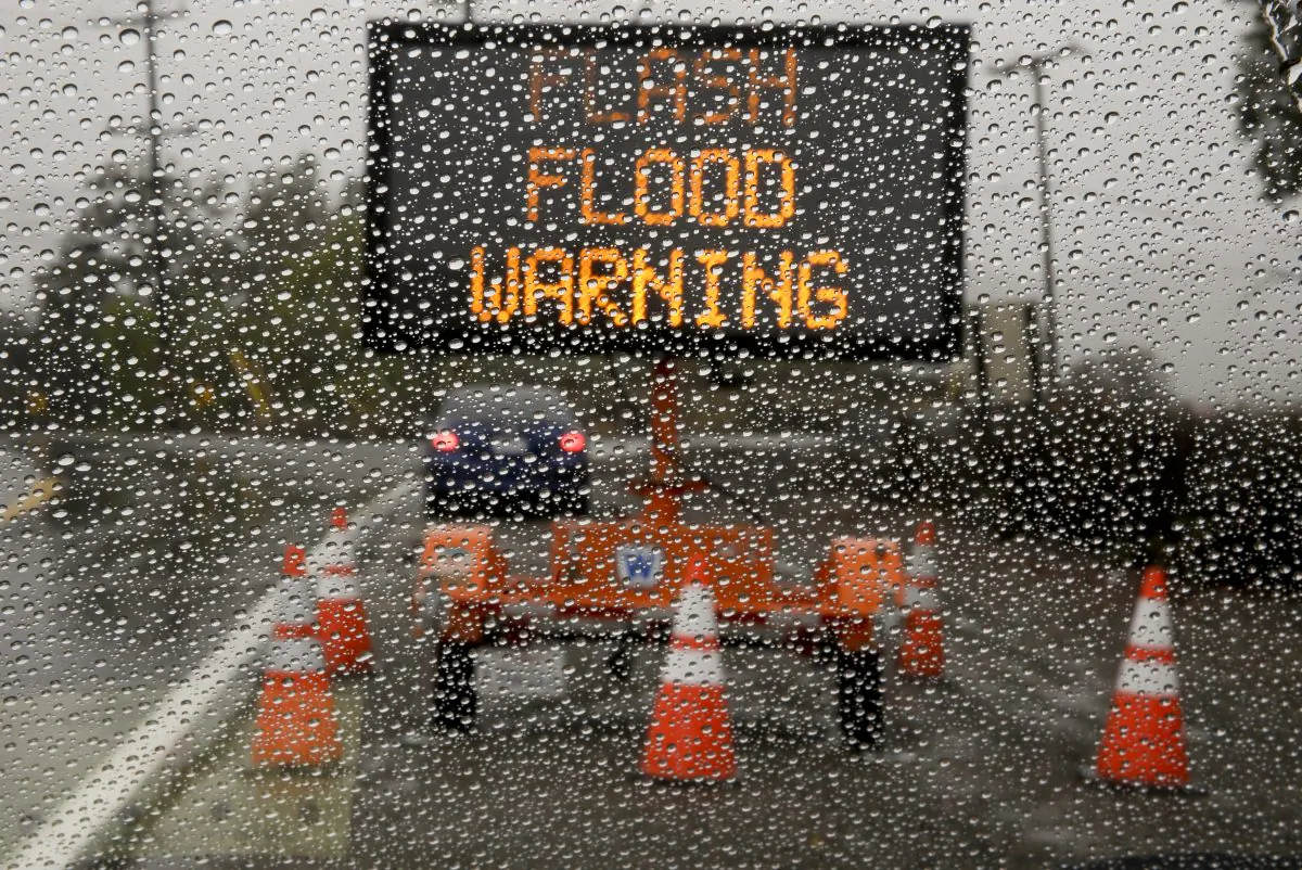 A sign warning of floods stands at the entrance to Silverado Canyon due to the potential for mud slides at a recent burn area in Silverado Canyon, Calif., Friday, Dec. 12, 2014.(Chris Carlson/AP Photo)