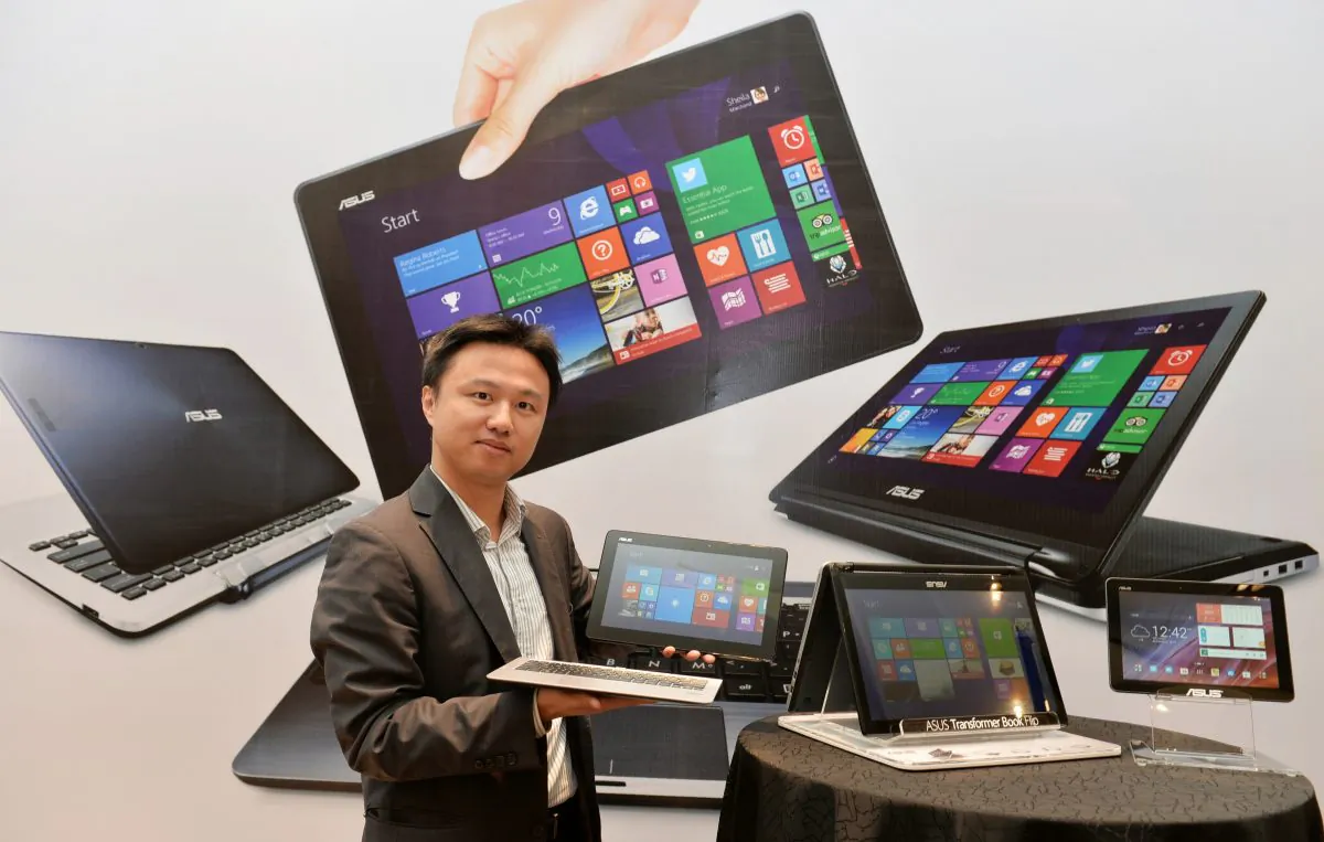 Peter Chang, Head of South Asia and Country Manager - System Business Group of ASUS India, showcases the company's Transformer Series of laptop/netbook/tablet combination during its launch in Bangalore on Nov. 14, 2014. (Manjunath Kiran/AFP/Getty Images)