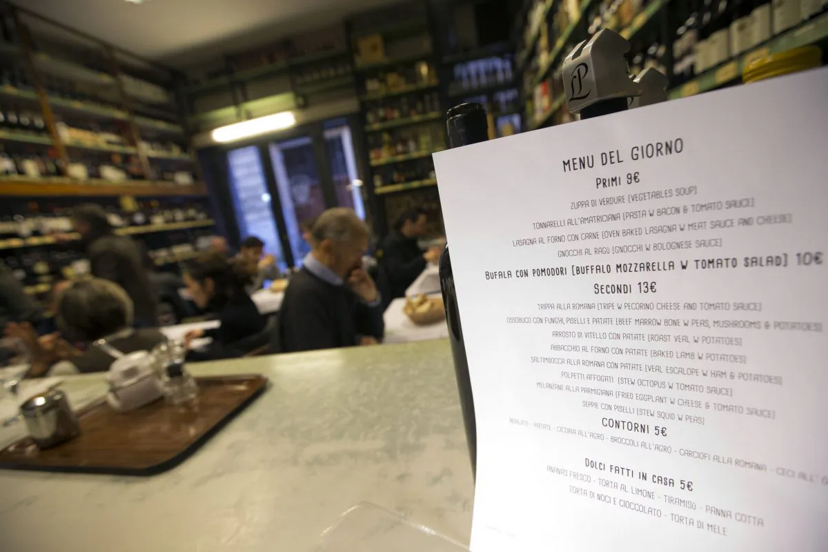 The menu of the Enoteca Corsi near the Pantheon is seen on the counter of one of its two dining rooms in Rome, Saturday, Dec. 13, 2014. A European rule requiring restaurants, bakeries and supermarkets — or anyone mass-producing meals — to list any of 14 allergens that might appear on their menus is being met with confusion. Italy and France, with their strong restaurant and cafe culture, had yet to outline how the rule approved three years ago should be put into effect. With constantly changing menus, cooks in both countries said communication with the customer — not more rules — was key to a good meal. (AP Photo/Andrew Medichini)