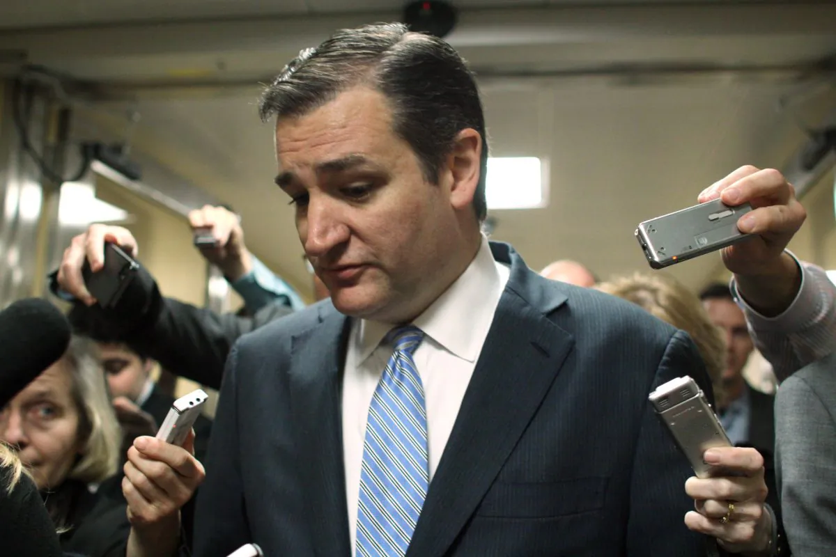 Sen. Ted Cruz (R-Texas) talks with reporters on Capitol Hill in Washington, Friday, Dec. 12, 2014, as the Senate considers a spending bill. The House has passed an additional stopgap spending to make certain the government doesn't shut down at midnight Saturday when current funding authority runs out. The move would give the Senate additional time to process a $1.1 trillion government-wide spending bill. (AP Photo/Lauren Victoria Burke)