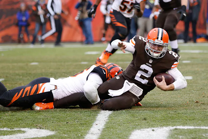 CLEVELAND, OH - DECEMBER 14: Johnny Manziel #2 of the Cleveland Browns gets tackled by Chris Carter #56 of the Cincinnati Bengals during the second quarter at FirstEnergy Stadium on December 14, 2014 in Cleveland, Ohio. (Photo by Joe Robbins/Getty Images)