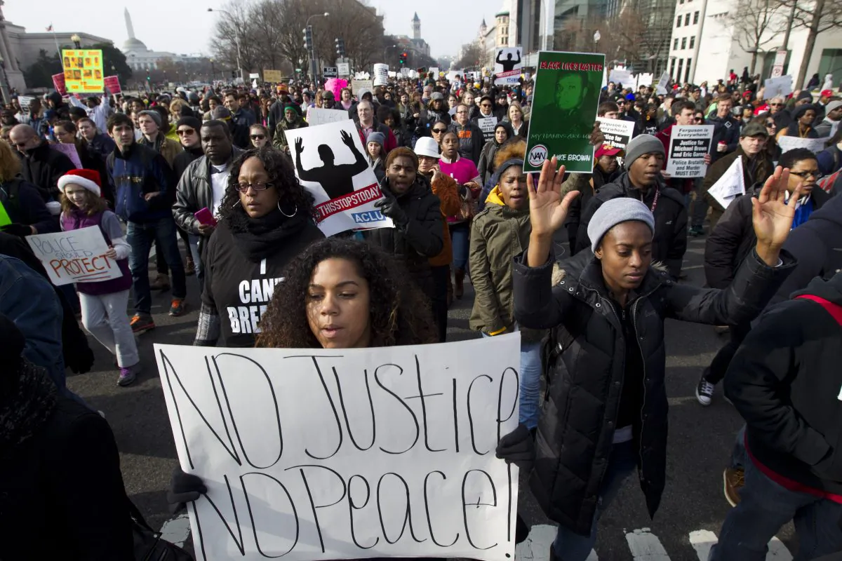 Demonstrators march on Pennsylvania Avenue toward Capitol Hill in Washington, Saturday, Dec. 13, 2014, during the Justice for All rally. More than 10,000 protesters are converging on Washington in an effort to bring attention to the deaths of unarmed black men at the hands of police. Civil rights organizations are holding a march to the Capitol on Saturday with the families of Michael Brown and Eric Garner, two unarmed black men who died in incidents with white police officers. (AP Photo/Jose Luis Magana)