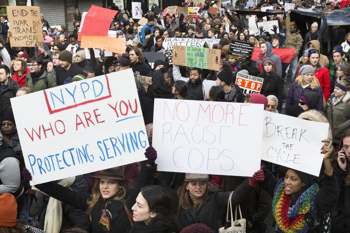 Demonstrators march in New York City, Saturday, Dec. 13, 2014, at the Justice for All march protesting civilian deaths caused by police officers. A Staten Island judge has ordered a public hearing to decide whether to disclose transcripts and evidence considered by the grand jury that voted not to indict the police officer who choked and killed Eric Garner. (AP Photo/John Minchillo)