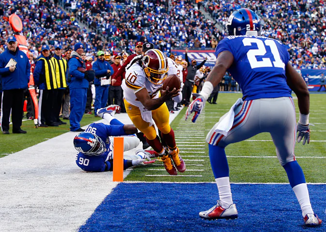 EAST RUTHERFORD, NJ - DECEMBER 14: Robert Griffin III #10 of the Washington Redskins fumbles the ball out of bounds in End Zone in the second quarter against the New York Giants during their game at MetLife Stadium on December 14, 2014 in East Rutherford, New Jersey. (Photo by Al Bello/Getty Images)