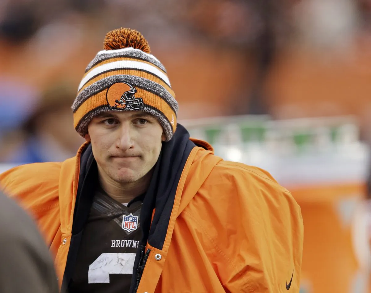 Cleveland Browns quarterback Johnny Manziel watches from the sidelines in the fourth quarter of an NFL football game against the Cincinnati Bengals Sunday, Dec. 14, 2014, in Cleveland. (AP Photo/Tony Dejak)